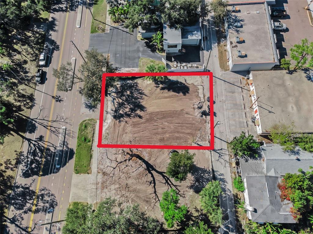 An aerial view shows a cleared, rectangular vacant lot outlined in red — 7309 1ST AVENUE S, ST PETERSBURG, FL