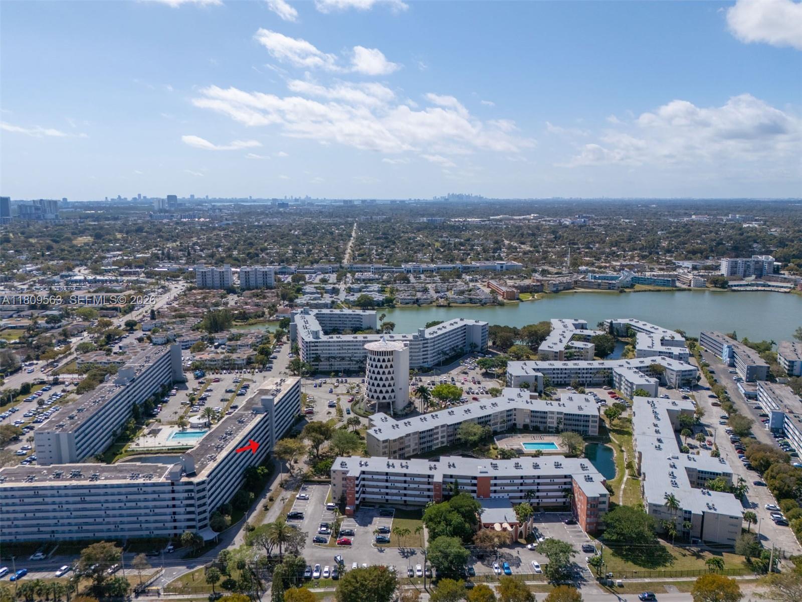 An aerial view shows a large residential apartment complex with multiple buildings, parking lots, and pools — 1770 NE 191st St # 1, Miami FL 33179, MIAMI, FL