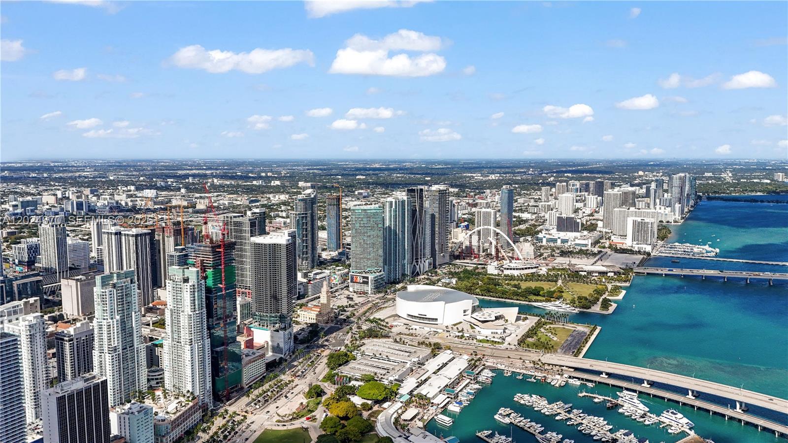 An aerial view of the Miami skyline featuring high-rise buildings, a marina, and a bridge — 398 NE 5th St # 2310, Miami FL 33132, MIAMI, FL