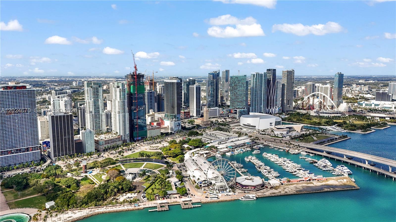 An aerial view of the Miami skyline featuring a marina, Ferris wheel, and high-rise buildings — 398 NE 5th St # 2310, Miami FL 33132, MIAMI, FL