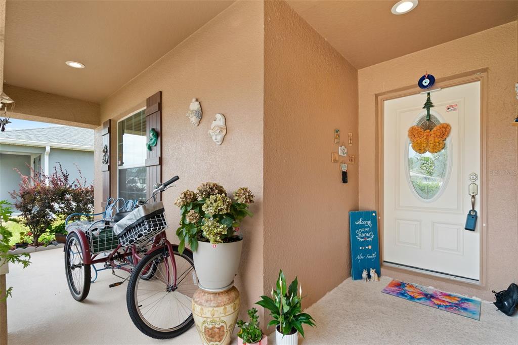 A tan stucco exterior features a white front door with an oval glass insert — 2014 DANES COURT, LAKELAND, FL