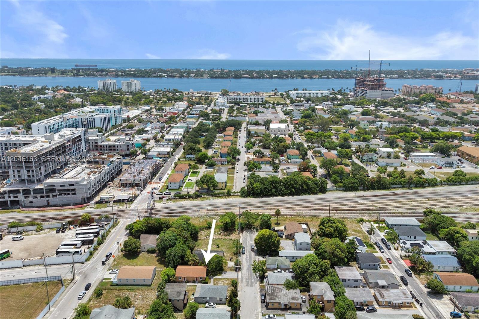 An aerial view shows a residential neighborhood with a white arrow pointing to a house — 727 22nd St # A, West Palm Beach FL 33407, WEST PALM BEACH, FL