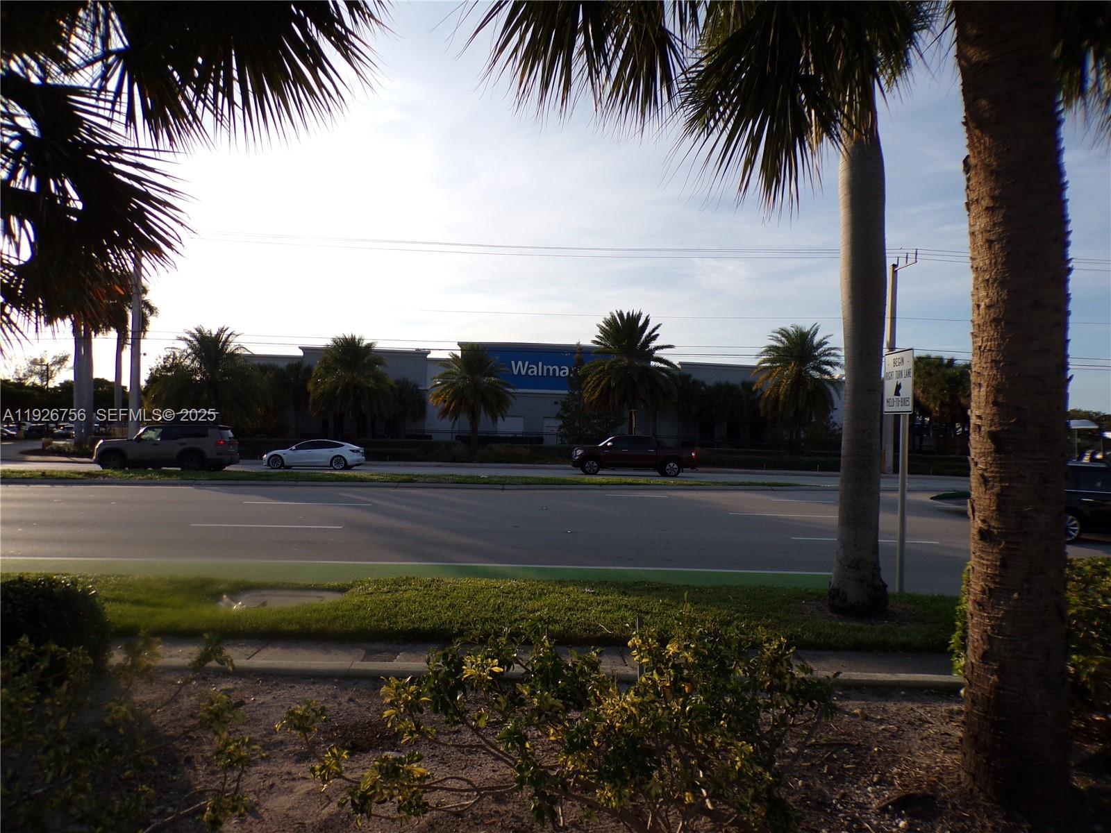 A view of a Walmart store across a multi-lane road framed by palm trees — 5030 N Federal Hwy, Lighthouse Point FL 33064, LIGHTHOUSE POINT, FL