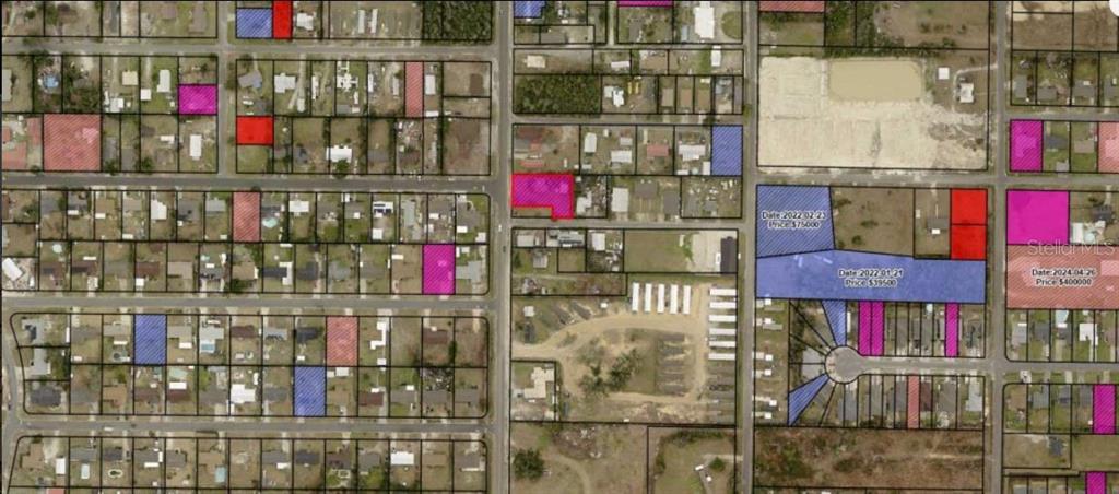 This is a map showing various land parcels with some highlighted in red, blue, and pink — 242 N HIGHWAY 22 A, PANAMA CITY, FL