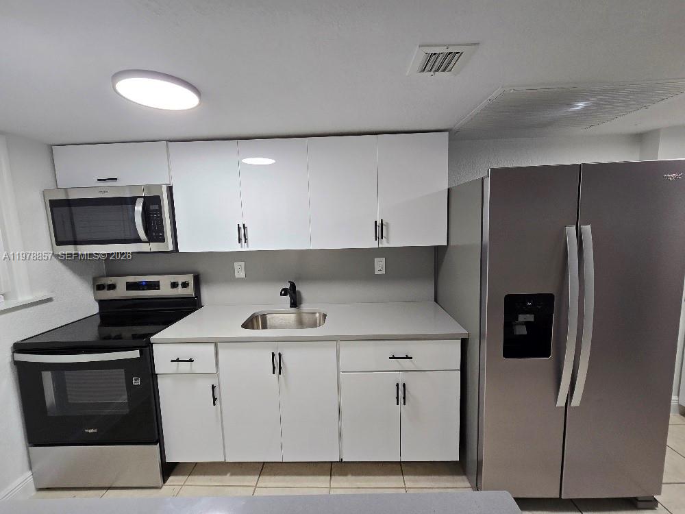 A kitchen features white cabinets, stainless steel appliances, and a gray countertop — 3901 SW 112th Ave # 38, Miami FL 33165, MIAMI, FL
