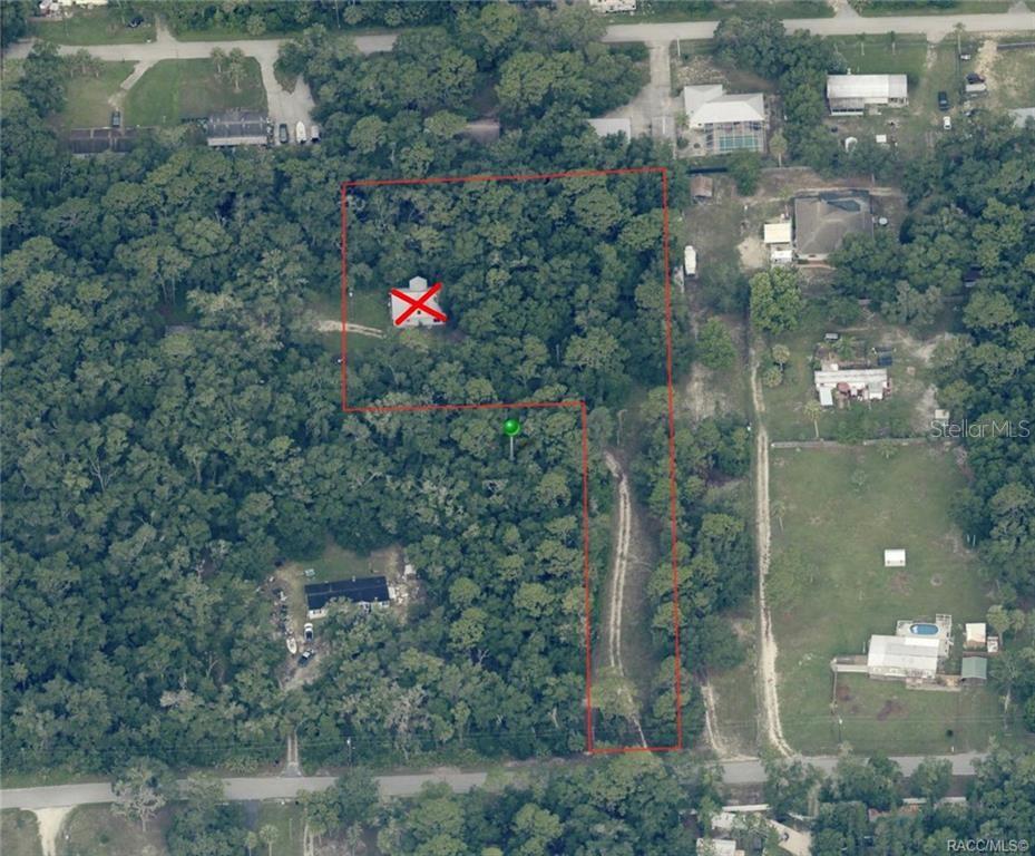 An aerial view shows a wooded lot with a house marked by a red X — 1628 S PALM AVENUE, HOMOSASSA, FL