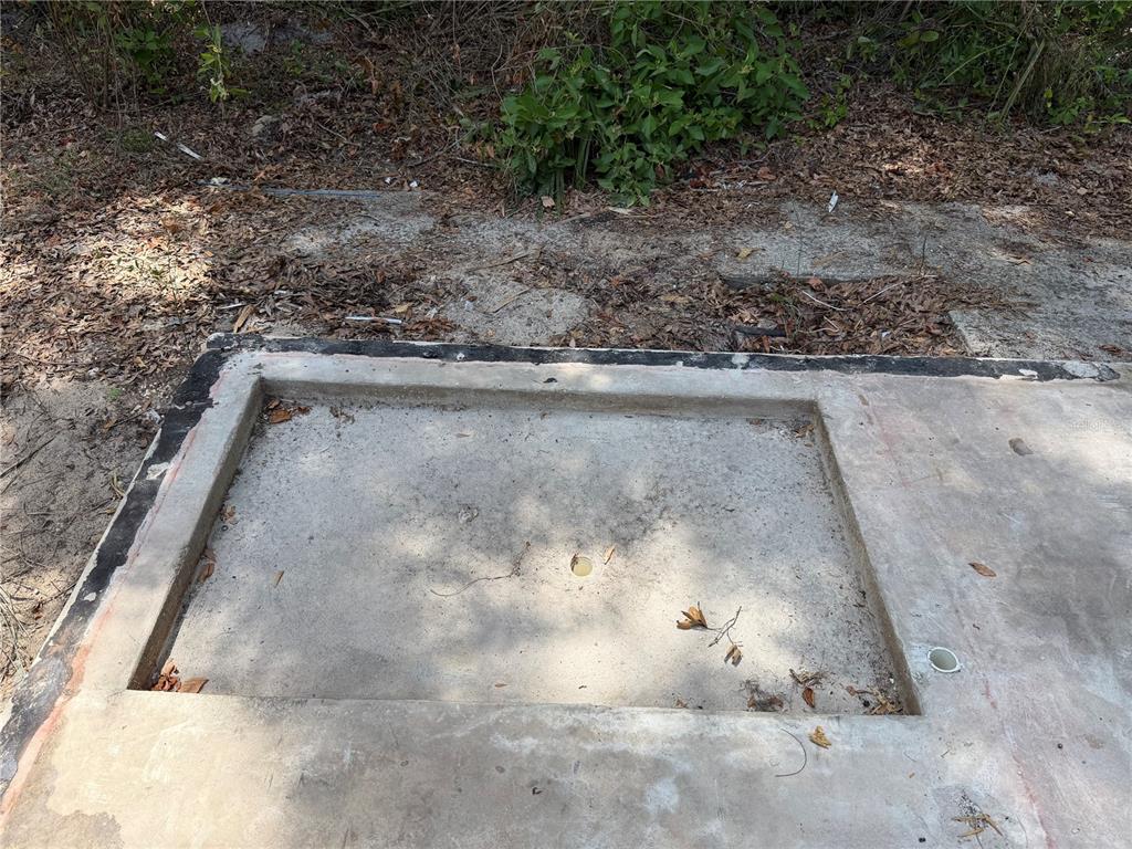 A rectangular concrete slab with a recessed center and two small drainage pipes — 1628 S PALM AVENUE, HOMOSASSA, FL