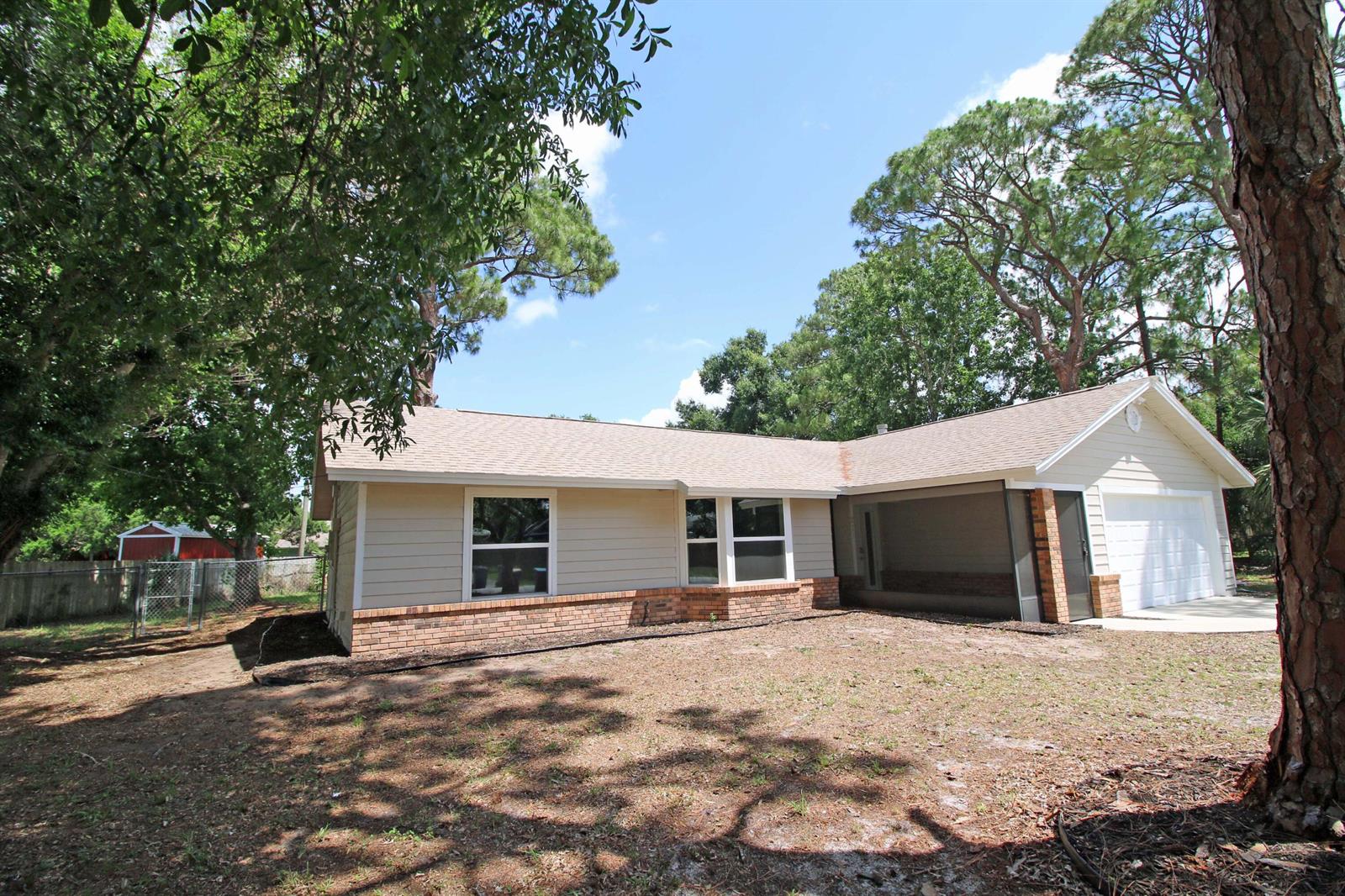 A single-story house with tan siding, a brick base, and a two-car garage — 271 Naylor NE, Palm Bay FL 32907, PALM BAY, FL