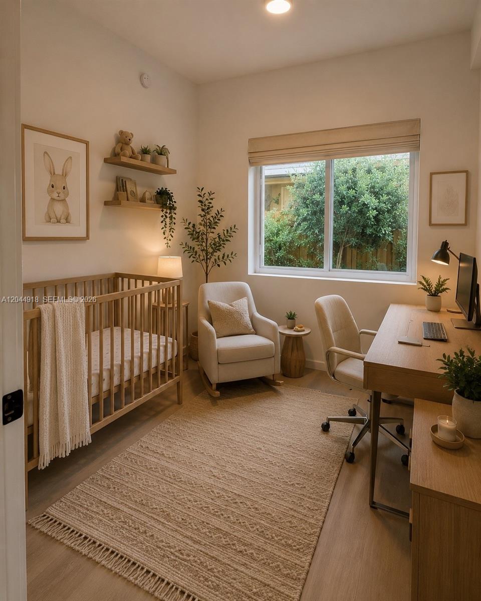 A nursery and home office combination featuring a wooden crib, desk, and rocking chair — 8106 NE 1st Ave # 16, Miami FL 33138, MIAMI, FL