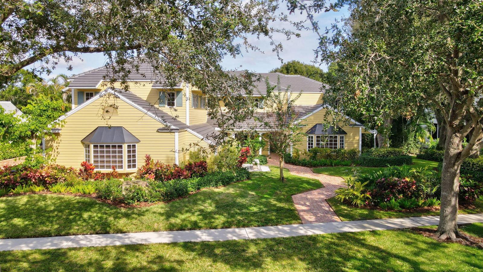 A yellow two-story house with a brick walkway and a large front lawn — 2883 Banyan Boulevard Circle NW, Boca Raton FL 33431, BOCA RATON, FL