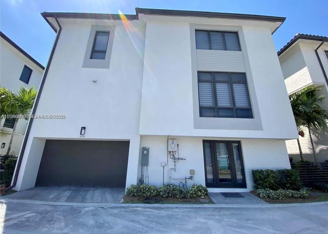 A modern two-story white house features a garage, dark-framed windows, and a front entryway — 8256 NW 48th ter, Doral FL 33166, DORAL, FL