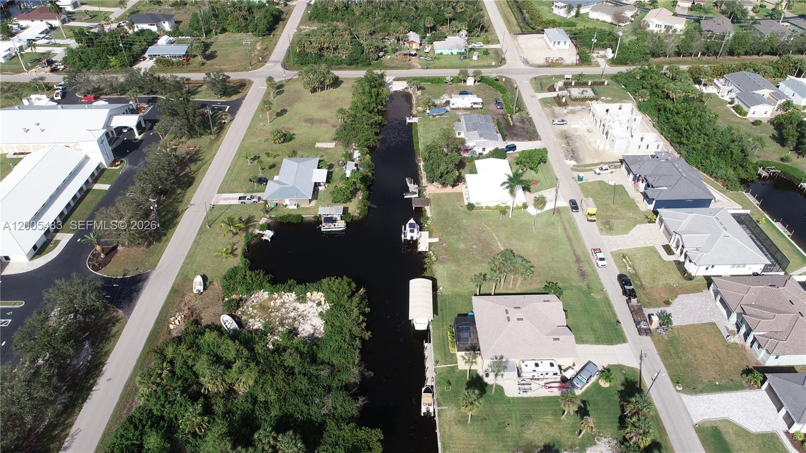 An aerial view shows houses along a canal with boats docked at private piers — 4114 PALM, Punta Gorda FL 33950, PUNTA GORDA, FL