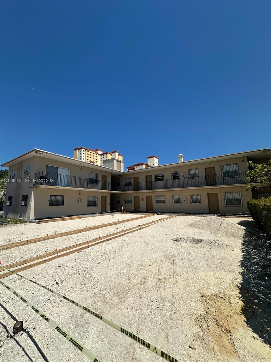 An exterior view of a two-story apartment building with a gravel courtyard under construction — 100 NE 78th St # 4, Miami FL 33138, MIAMI, FL