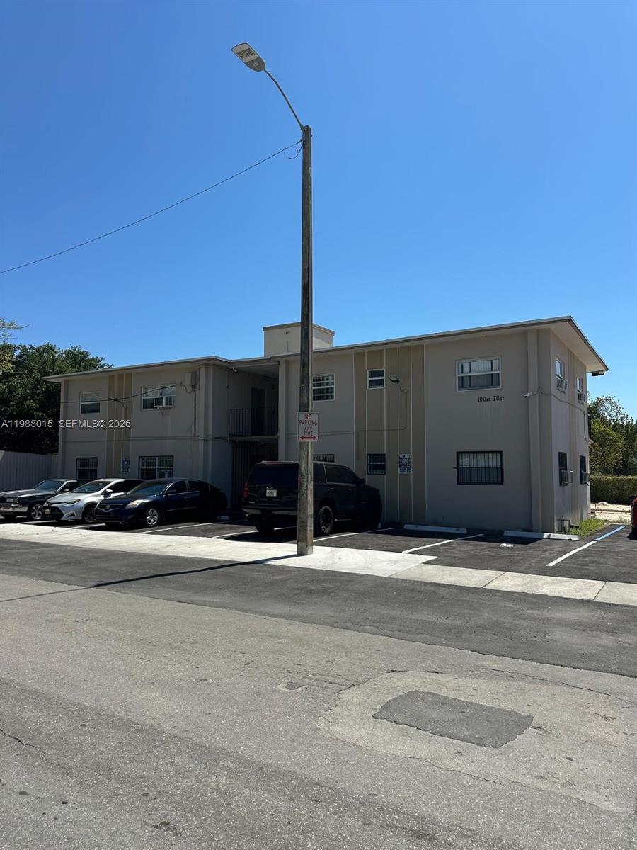 A two-story apartment building with a parking lot in front and a street lamp — 100 NE 78th St # 4, Miami FL 33138, MIAMI, FL
