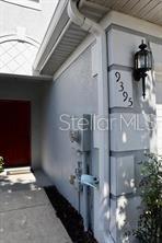 A view of a house exterior showing a red front door and a house number — 9395 FLOWERING COTTONWOOD ROAD UNIT 32, ORLANDO, FL