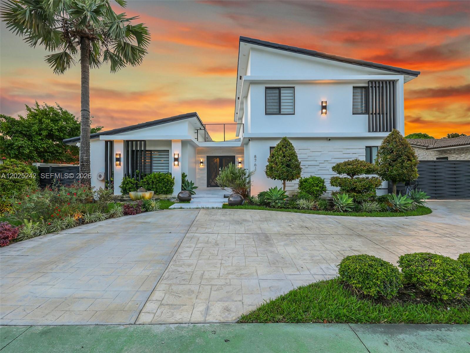 A modern two-story house with a white exterior, flat roof, and a paved driveway — 8761 SW 56th St, Miami FL 33165, MIAMI, FL