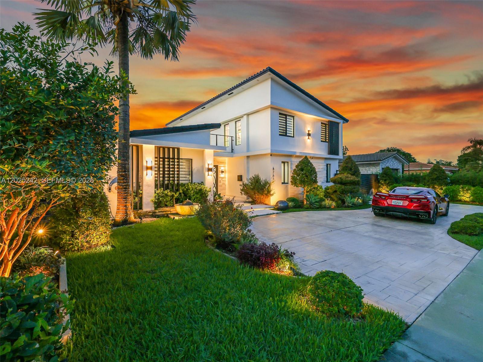 A modern two-story house with a red sports car parked on the paved driveway — 8761 SW 56th St, Miami FL 33165, MIAMI, FL