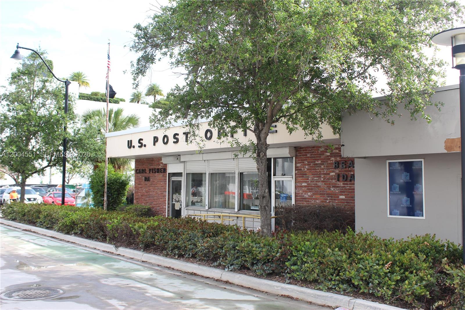 The exterior of a brick U.S. Post Office building features a tree and landscaping — 1661 West Ave, Miami Beach FL 33139, MIAMI BEACH, FL