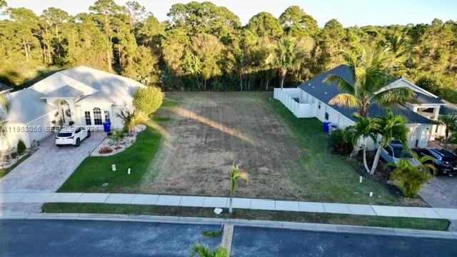 An aerial view shows a vacant residential lot situated between two houses — 1570 SW 16th Ct SW, Vero Beach FL 32962, VERO BEACH, FL