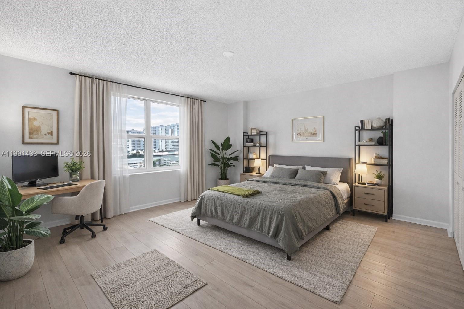 A bedroom features a bed, desk, shelving units, and a window with a city view — 701 Brickell Key Blvd # 1108, Miami FL 33131, MIAMI, FL