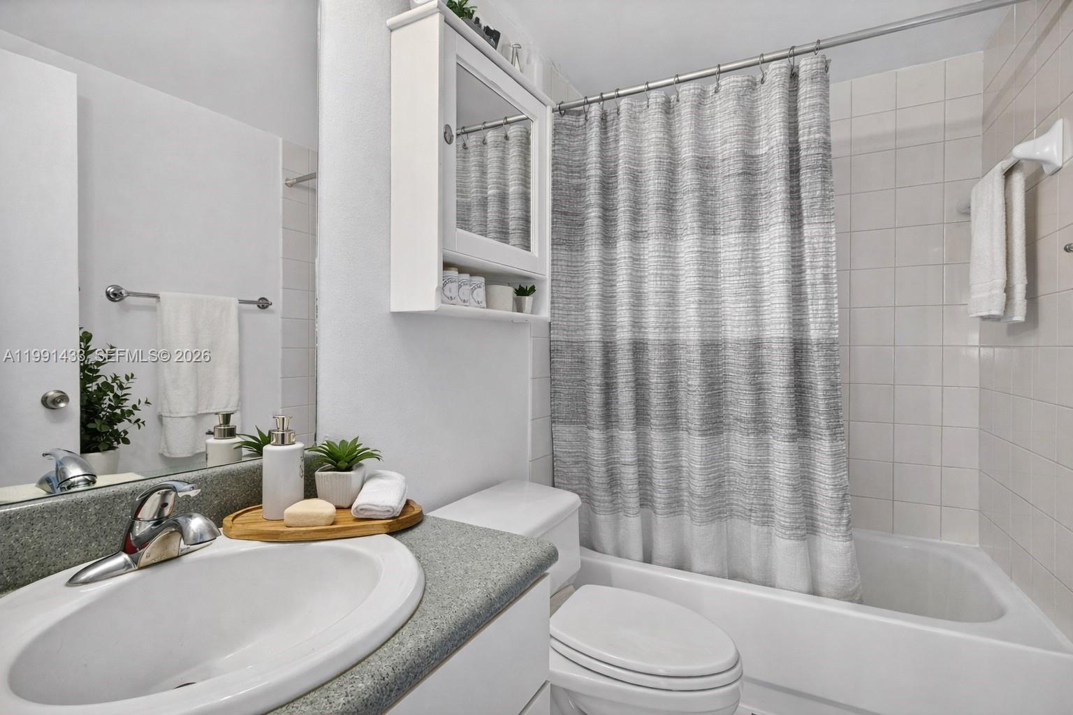 A bathroom features a vanity with a gray countertop, a toilet, and a shower-tub combination — 701 Brickell Key Blvd # 1108, Miami FL 33131, MIAMI, FL
