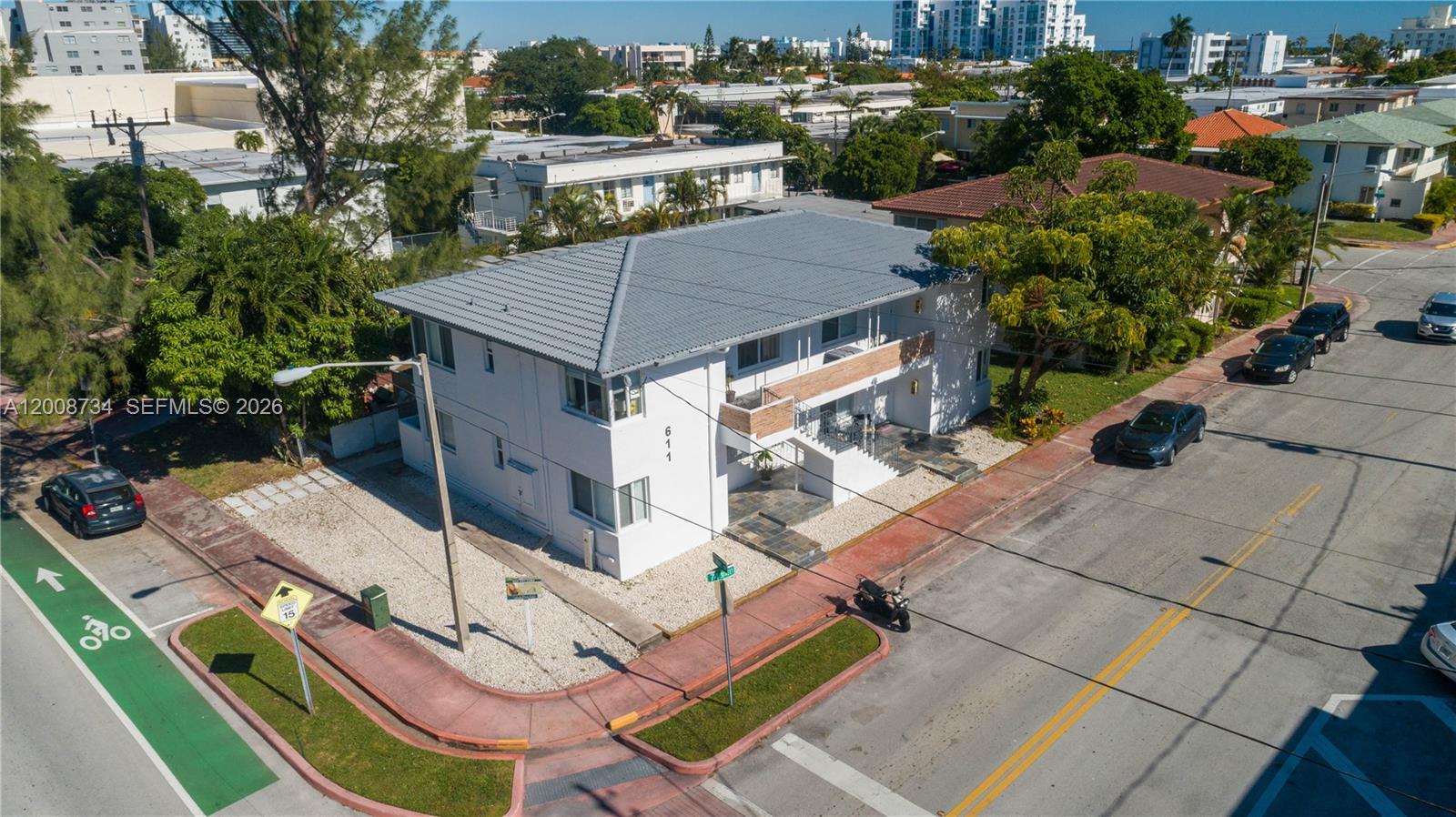 An aerial view shows a two-story white apartment building on a corner lot — 611 74th St, Miami Beach FL 33141, MIAMI BEACH, FL