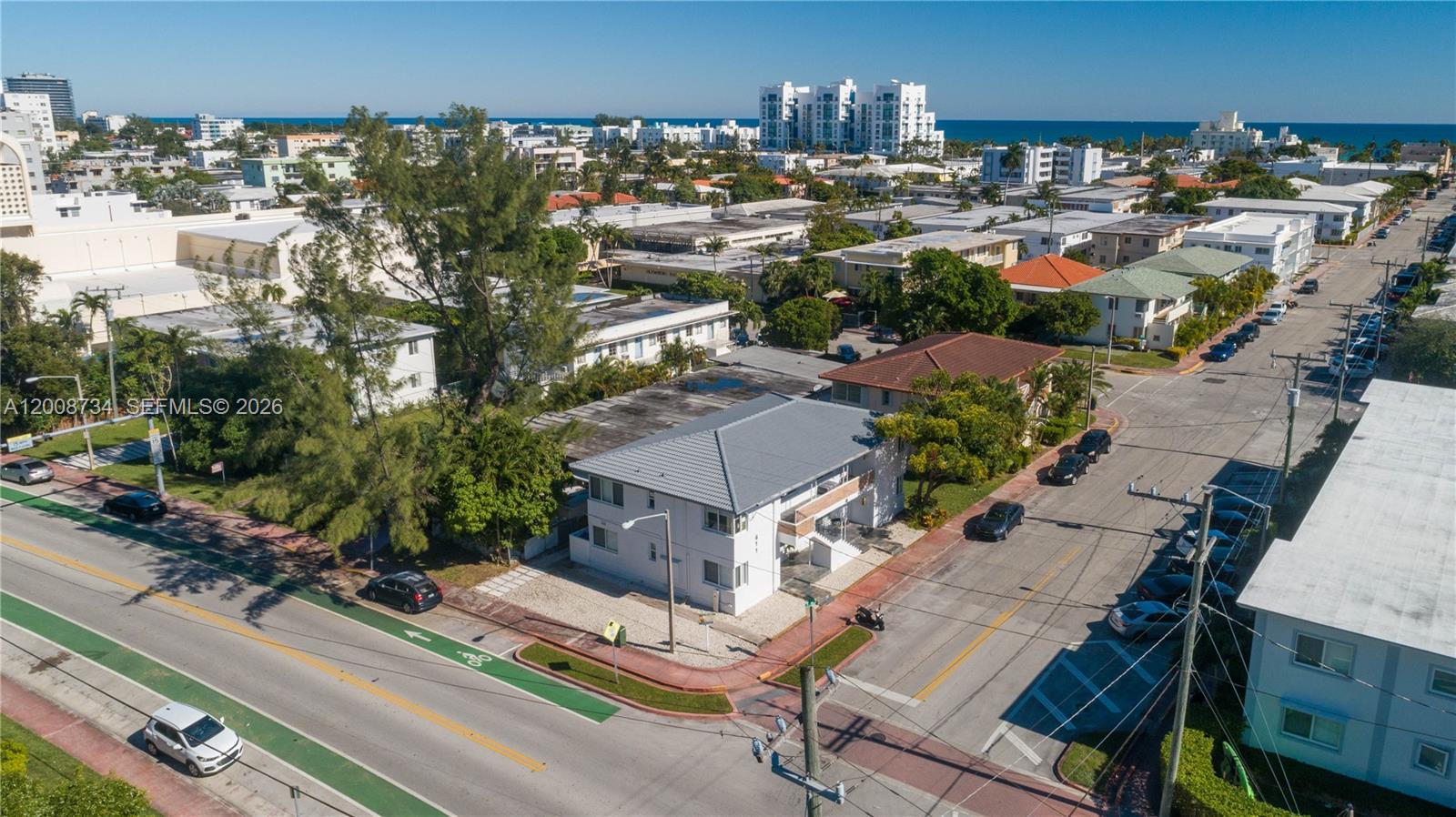 An aerial view shows a two-story white apartment building at a street corner — 611 74th St, Miami Beach FL 33141, MIAMI BEACH, FL