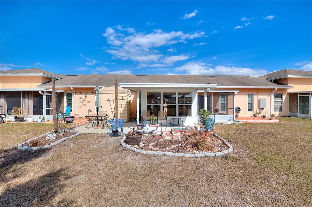 The exterior view shows a single-story house with a patio, landscaping, and a grassy yard — 5109 CLUB CIRCLE, LAKE WALES, FL