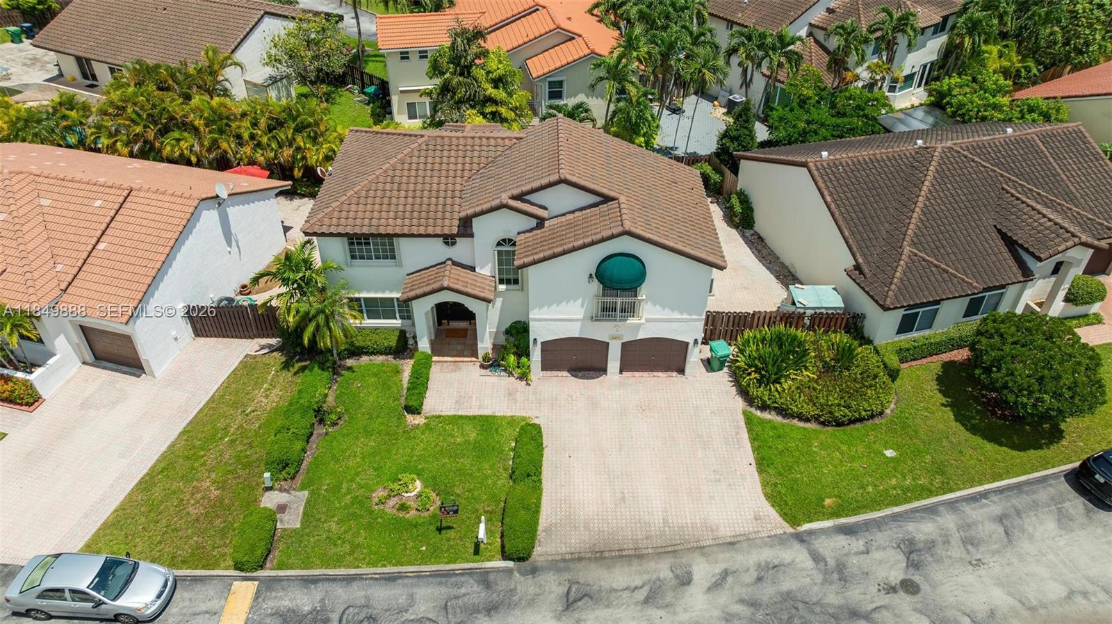 An aerial view shows a two-story suburban house with a tiled roof and driveway — 4471 SW 154th Ct, Miami FL 33185, MIAMI, FL