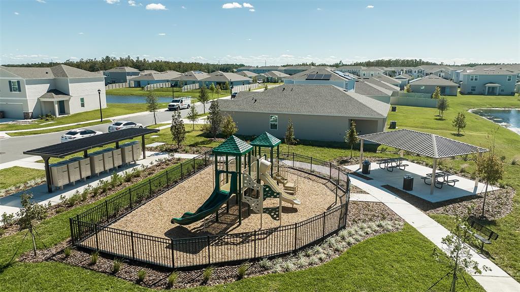 An aerial view shows a fenced playground with slides, a picnic pavilion, and mailboxes — 5431 ISLA SAONA DRIVE, KISSIMMEE, FL
