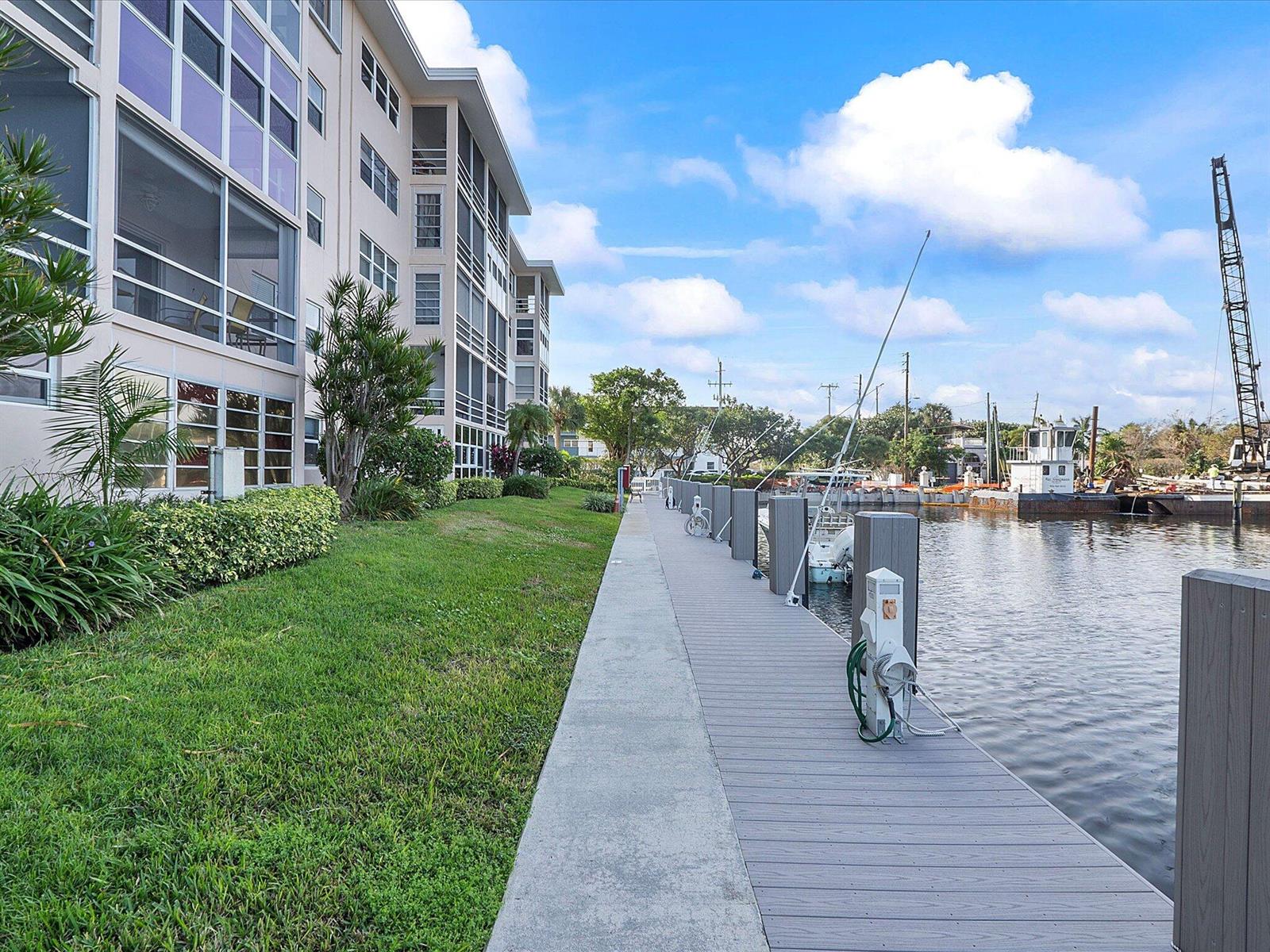 A concrete walkway runs alongside a multi-story building and a wooden boat dock — 1481 S Ocean Boulevard # 315a, Pompano Beach FL 33062, POMPANO BEACH, FL