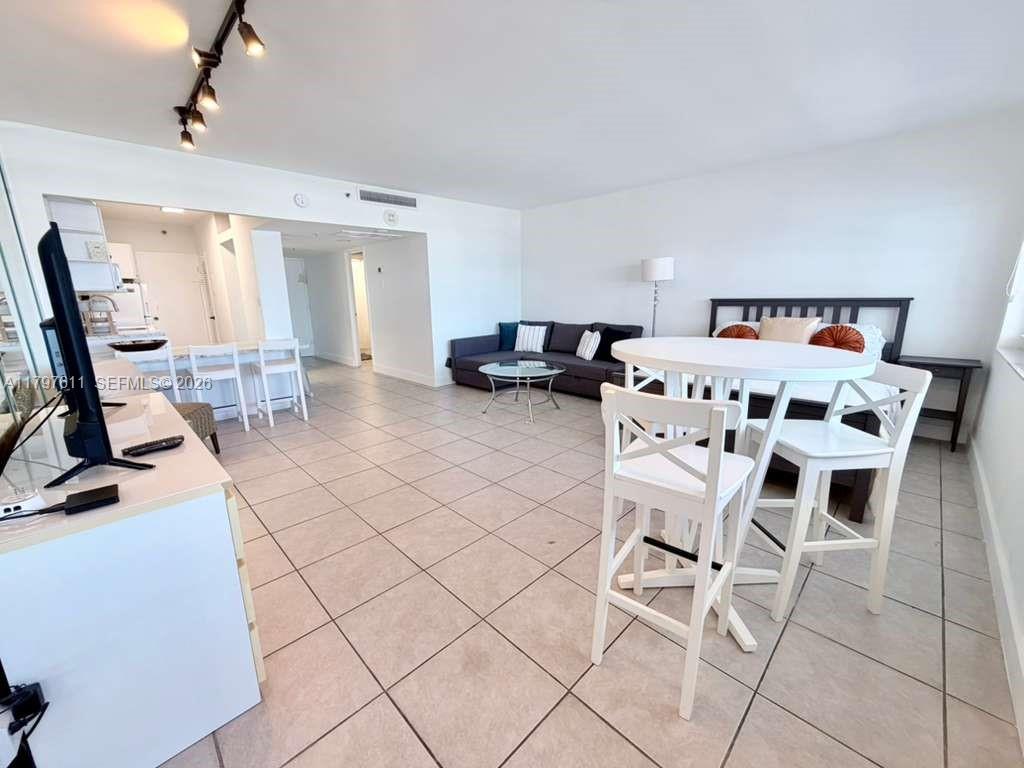 This studio apartment features a kitchen, living area, and bed with light tile flooring — 100 Lincoln Rd # 1220, Miami Beach FL 33139, MIAMI BEACH, FL