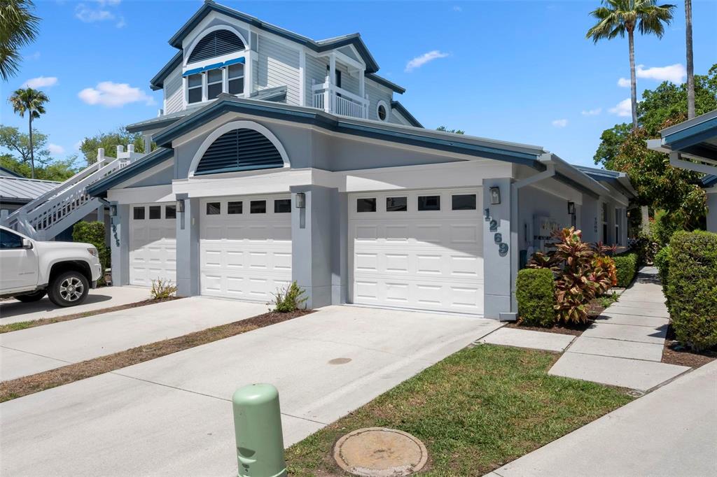 A two-story house with a gray exterior, white trim, and two white garage doors — 1269 SIESTA BAYSIDE DRIVE UNIT 1269C, SARASOTA, FL