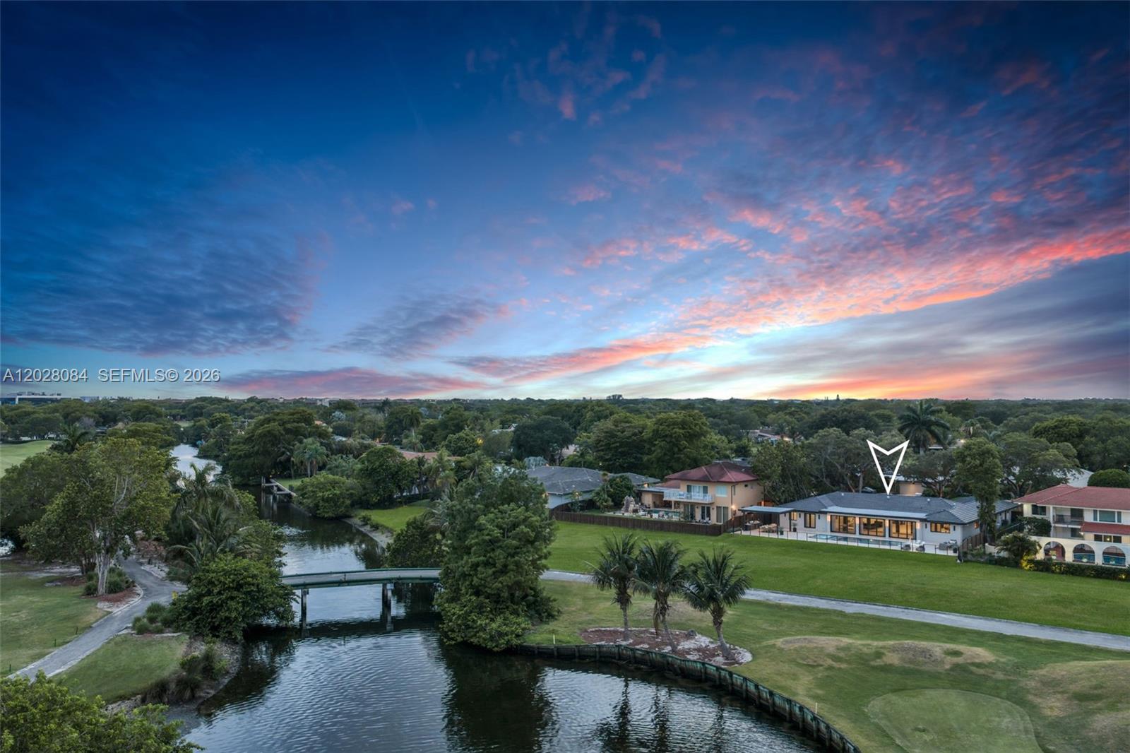An aerial view shows a house with a pool overlooking a canal and golf course — 4220 Casper Ct, Hollywood FL 33021, HOLLYWOOD, FL