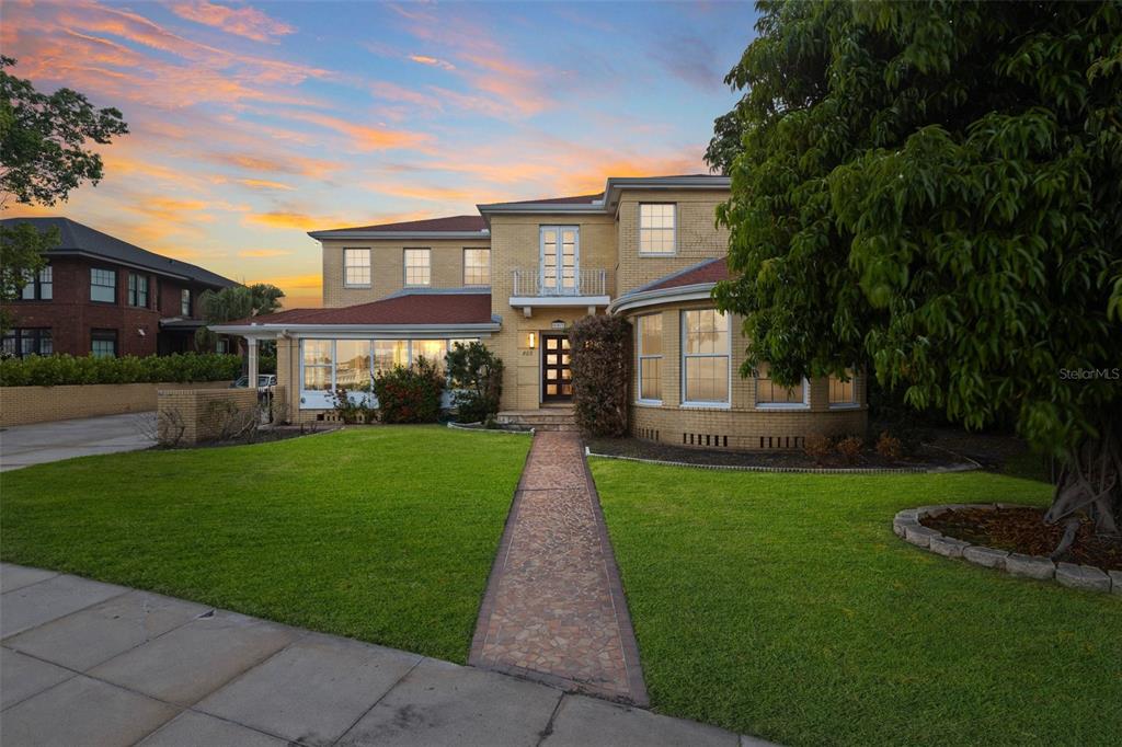 A two-story yellow brick house with a red roof and a stone walkway — 803 BAYSHORE BOULEVARD, TAMPA, FL