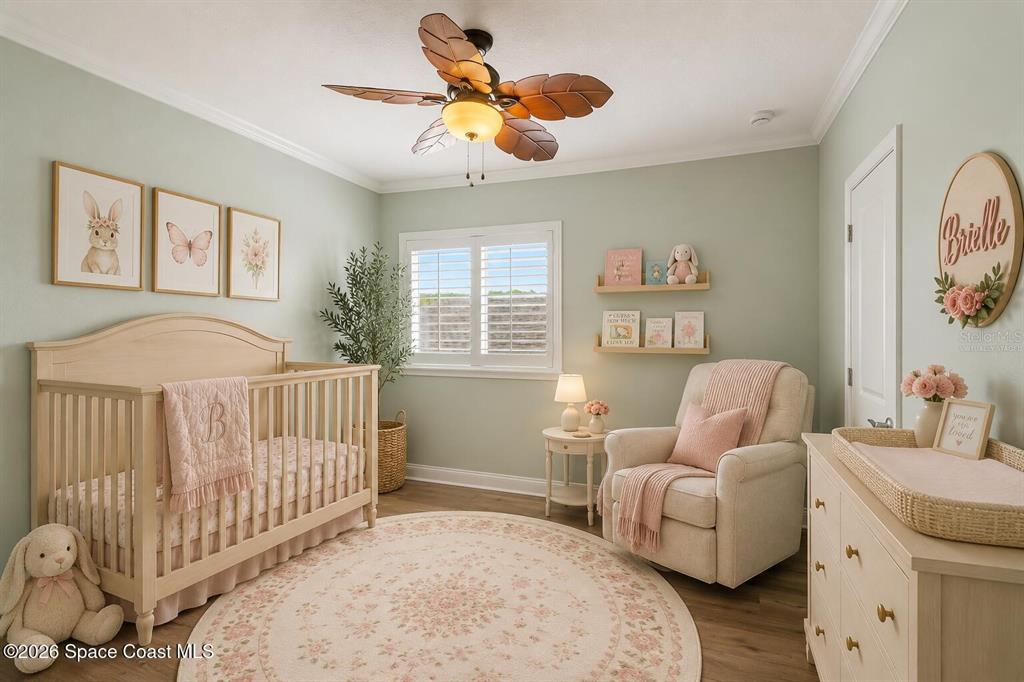 A nursery features a wooden crib, a rocking chair, and a round floral area rug — 10651 LANGEFIELD STREET, ORLANDO, FL