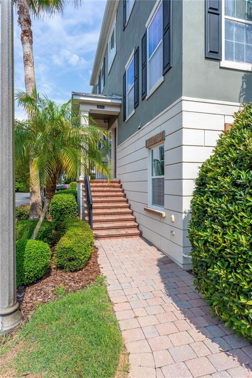 A brick walkway leads to a set of stairs at the entrance of a building — 2595 JOSLIN PLACE, ORLANDO, FL