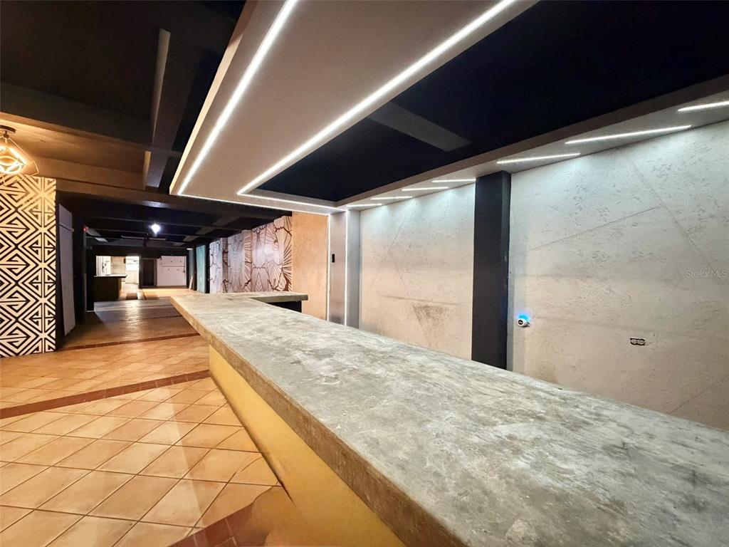 A long concrete bar counter sits in a room with tiled floors and recessed lighting — 1204 PONCE DE LEON AVENUE UNIT LOCAL A, SAN JUAN, PR