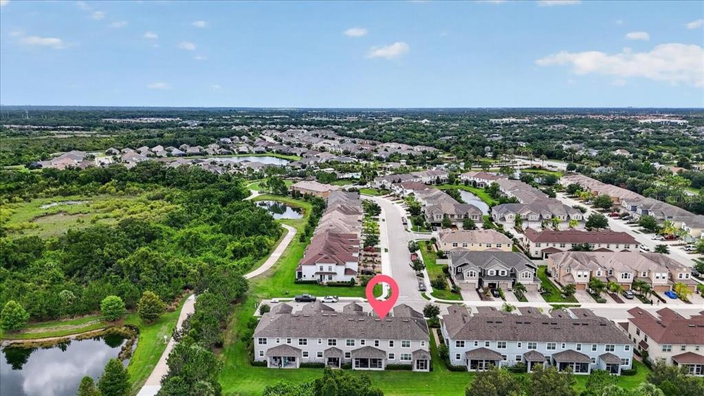 An aerial view shows a multi-unit townhouse complex with a pink location marker — 5057 SKYVIEW LANE, BRADENTON, FL