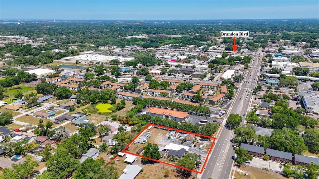 An aerial view shows a vacant lot outlined in red next to a busy road — 504 S KINGS AVENUE, BRANDON, FL