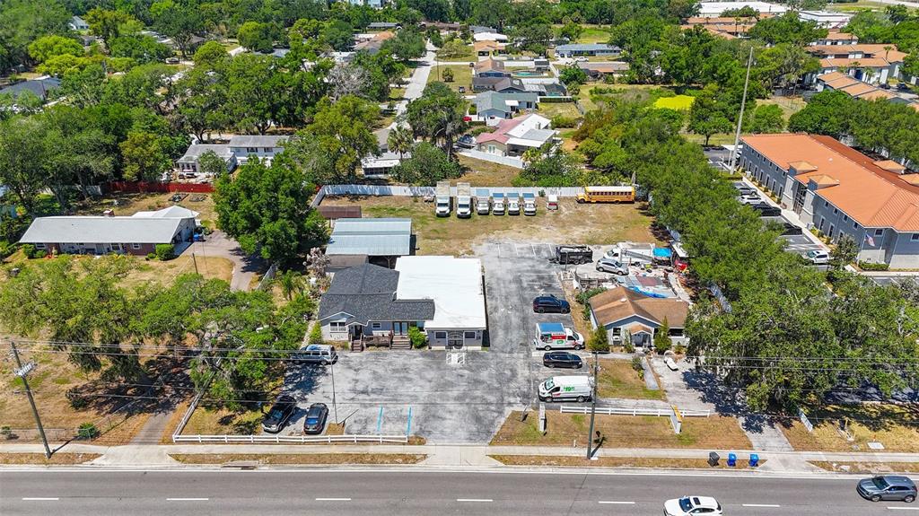 An aerial view shows a commercial property with a parking lot and several small buildings — 504 S KINGS AVENUE, BRANDON, FL