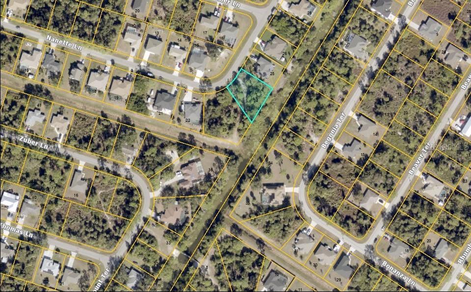 This is an aerial map showing a vacant lot highlighted in blue within a residential neighborhood — MC GINNIS TERRACE, NORTH PORT, FL