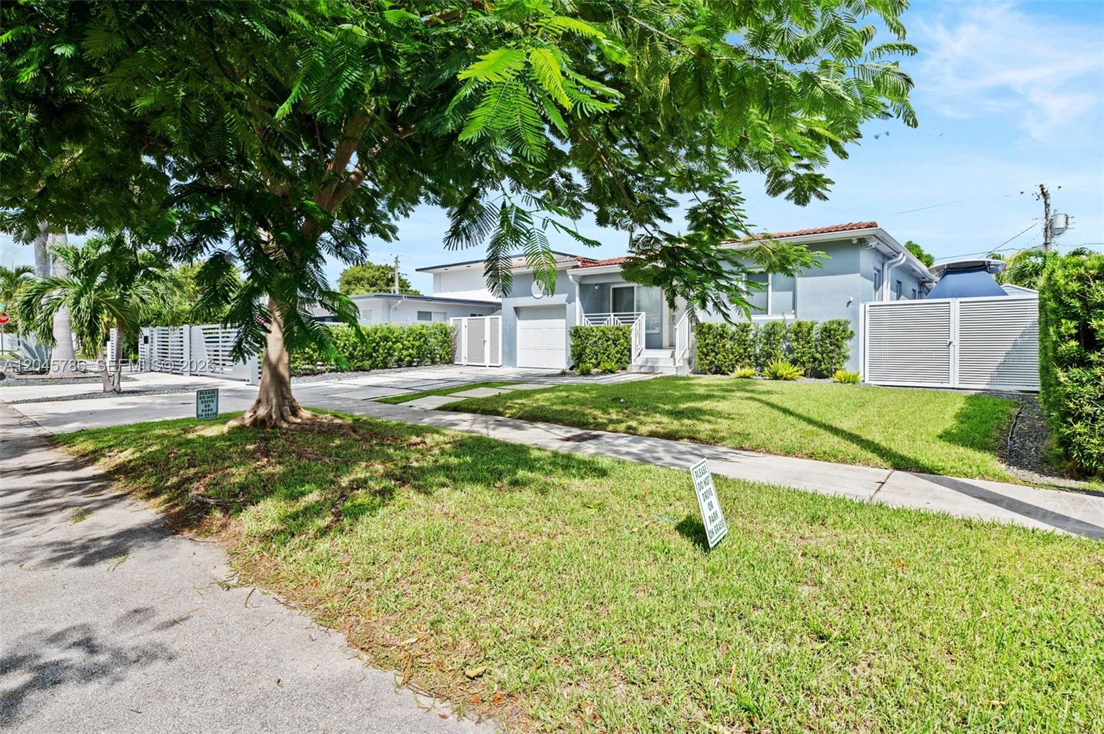 A single-story house with a light blue exterior, a front lawn, and a paved driveway — 4355 SW 2nd St, Miami FL 33134, MIAMI, FL