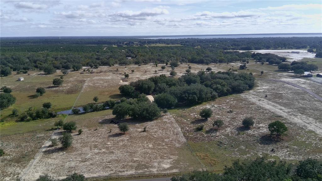 An aerial view shows a large, mostly cleared rural lot with scattered trees and vegetation — 4547 GLENN SAINT MARY ROAD, LAKE WALES, FL