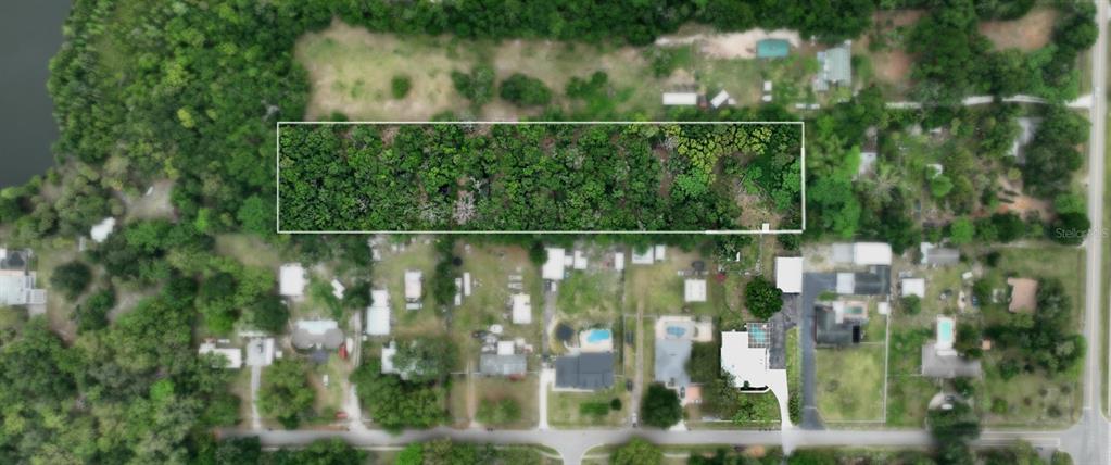 An aerial view shows a rectangular, wooded plot of land outlined in white — OLD CONE GROVE ROAD, RIVERVIEW, FL