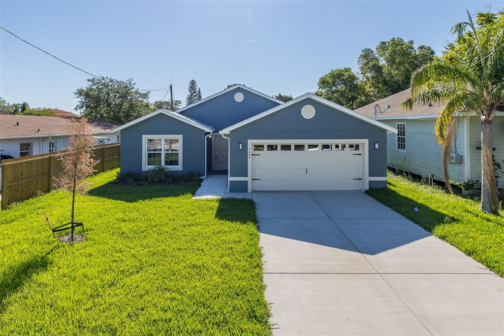 A blue single-story house with a white garage door and a concrete driveway — 5422 CHARLES STREET, NEW PORT RICHEY, FL