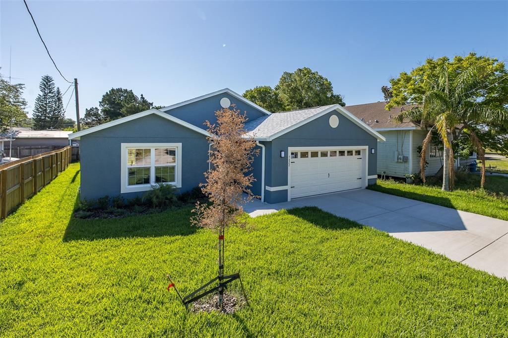 A blue single-story house with a white garage door and a front lawn — 5422 CHARLES STREET, NEW PORT RICHEY, FL