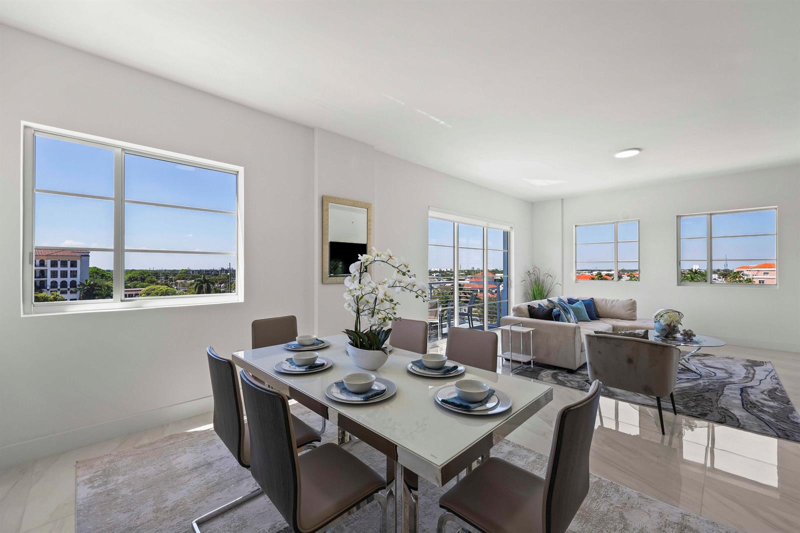 A dining area with a glass-topped table and chairs opens into a bright living room — 155 E Boca Raton Road # 723, Boca Raton FL 33432, BOCA RATON, FL