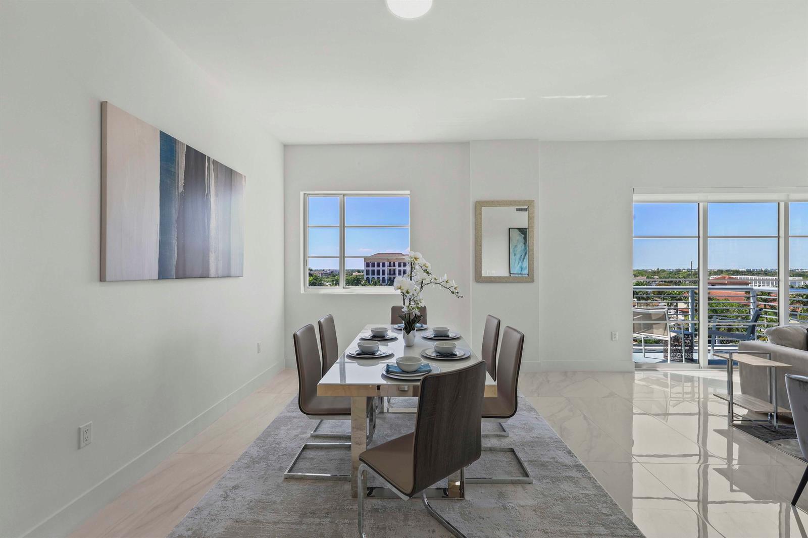 A dining room features a glass table with six chairs on a gray area rug — 155 E Boca Raton Road # 723, Boca Raton FL 33432, BOCA RATON, FL
