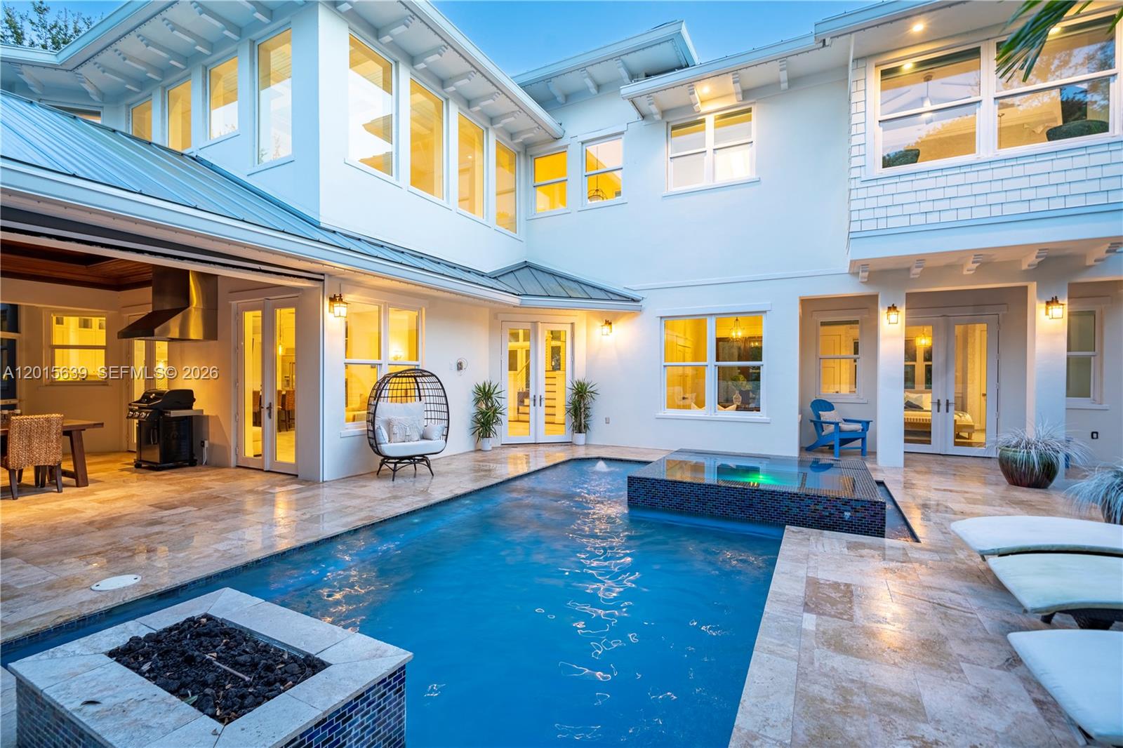 A courtyard features a swimming pool, a raised spa, and a fire pit — 545 SW Indianola St, Stuart FL 34994, STUART, FL